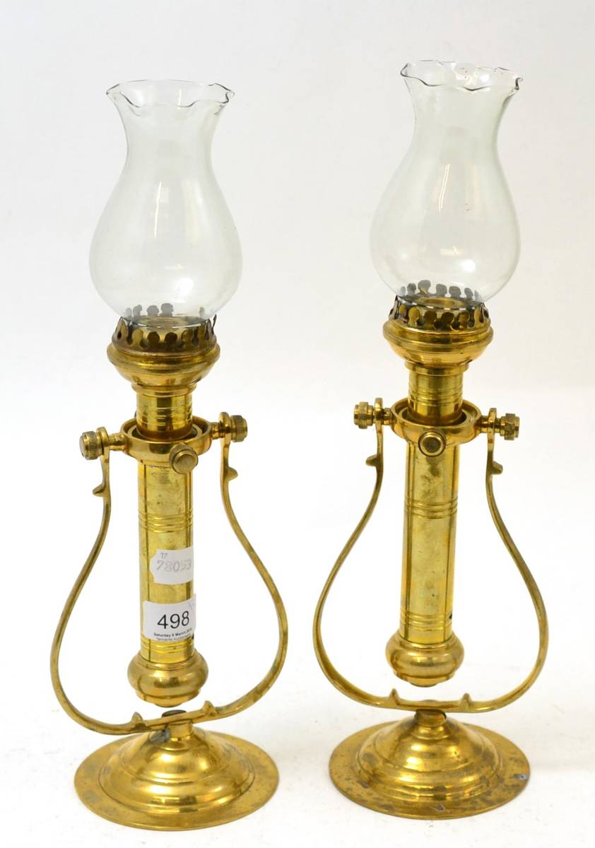 Lot 498 - A pair of 19th century brass candle wall sconces on gimbals, with shades