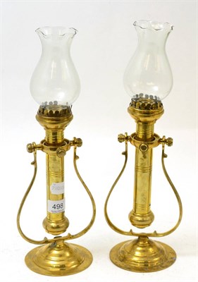 Lot 498 - A pair of 19th century brass candle wall sconces on gimbals, with shades