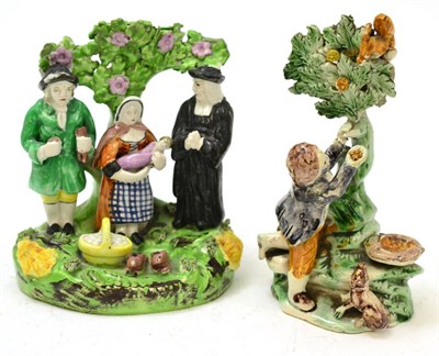 Lot 508 - Two Staffordshire figure groups, a Prattware with squirrel and a Tythe pig