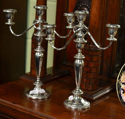 Lot 527 - A pair of three light candelabra, underside stamped Poole, sterling silver, weighted