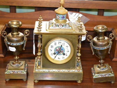 Lot 535 - A brass and champleve enamel striking clock garniture (one foot missing)