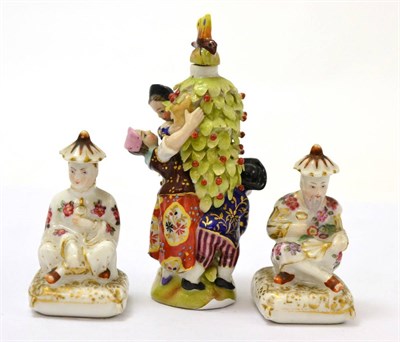 Lot 562 - A pair of porcelain scent bottles modelled as Chinese figures and a Sitzendorf scent bottle