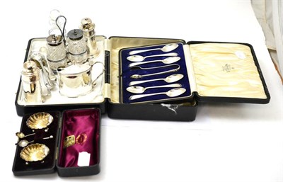 Lot 567 - A small group of silver including a cased pair of shell form salts, cased tea spoons, three...