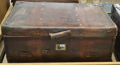 Lot 1001 - Two early 20th century studded leather travelling trunks