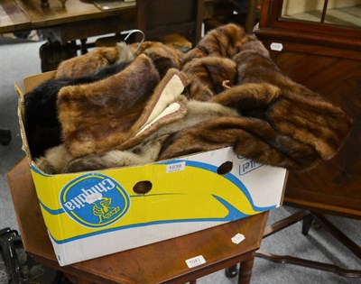 Lot 1039 - A musquash fur coat, another similar, a fur muff, black mink hat and two stoles