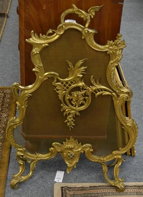 Lot 1050 - A Rococo style gilt metal fire screen