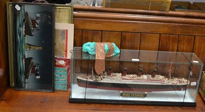 Lot 1053 - A group of transport related items including a model of RMS Titanic (in glass case), a painting...