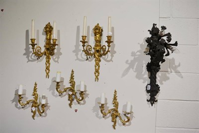 Lot 1058 - A pair of gilt metal twin light candle wall sconces, a set of three gilt metal electric wall...