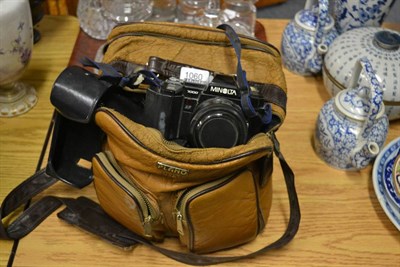 Lot 1060 - A Minolta 7000 camera together with a small group of lenses in a leather bag