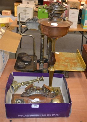 Lot 1076 - A copper and brass oil lamp with a Hinks burner, pair of brass candlesticks and an oak desk...