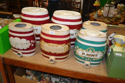 Lot 1110 - Two pairs of pottery spirit barrels and two other single examples