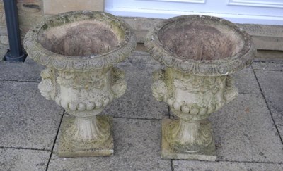 Lot 1154 - A pair of composition garden urns