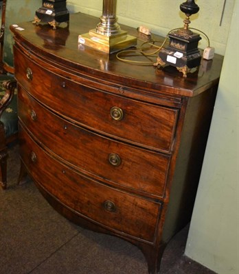 Lot 1280 - A George III mahogany bow fronted three height chest of drawers with dressing slide