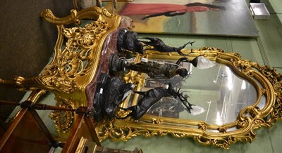 Lot 1287 - Pair of substantial mirror backed marble topped gilt composition console tables in the Rococo taste