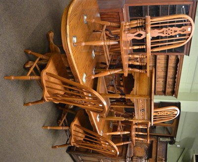 Lot 1300 - An oak dining table together with six chairs