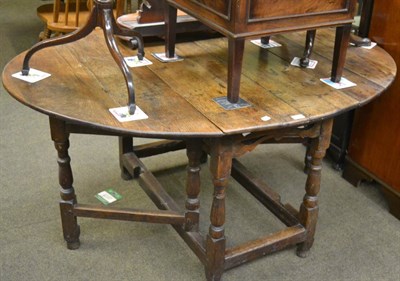 Lot 1319 - A provincial oak gate leg dining table