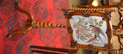 Lot 1334 - A turned and carved Victorian mahogany pole screen decorated with a needlework panel of a bird