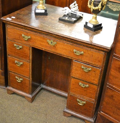 Lot 1340 - An oak knee hole desk of small proportions