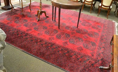 Lot 1343 - A Turkmen carpet, North Afghanistan , the claret field with three columns of 'elephant foot'...