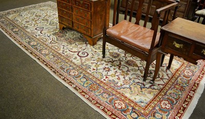 Lot 1365 - An Amritsar gallery carpet, the ivory field with a lattice of angular vines and palmettes...