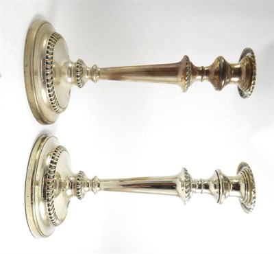 Lot 59 - A pair of loaded silver candlesticks by Walker & Hall