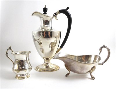 Lot 68 - A silver hot water jug together with a silver plated sauce boat and a silver plated christening mug