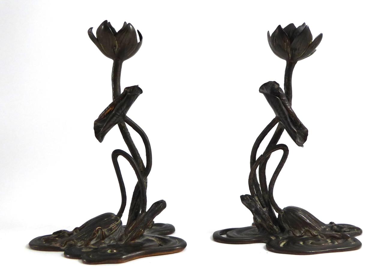 Lot 70 - A pair of Art Nouveau cast water lily candlesticks