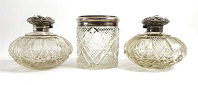 Lot 73 - A pair of silver mounted cut glass scent flasks and another circular section jar (3)
