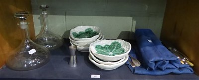 Lot 83 - A group of majolica plates, pair of etched glass decanters, silver plate etc