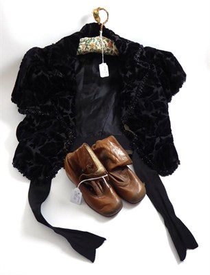 Lot 85 - A Victorian black velvet devore fitted jacket with beadwork jacket and a pair of brown leather...
