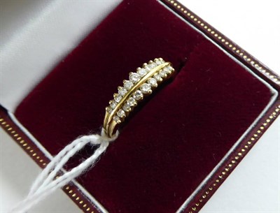 Lot 123 - An 18ct gold diamond two line half hoop ring
