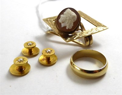 Lot 134 - A set of three 18ct gold seed pearl set dress studs, a 9ct gold clip, a cameo ring and a metal band