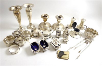 Lot 176 - A group of silver including various condiments, napkin rings, sugar tongs, dwarf candlesticks,...