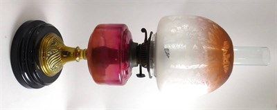 Lot 180 - A Victorian oil lamp with cranberry font and etched glass shade
