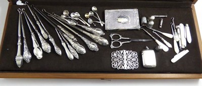 Lot 201 - A collection of silver handled button hooks, thimbles, silver backed note book, silver vesta,...