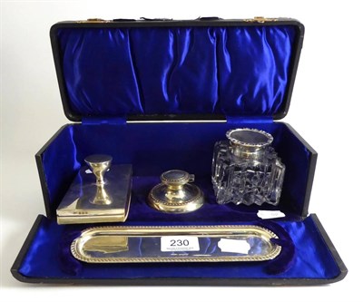 Lot 230 - A Mappin & Webb silver mounted inkwell, silver blotter, silver pen tray and a silver inkwell with a