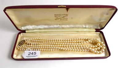 Lot 245 - A three row cultured pearl necklace on 9ct gold seed pearl set clasp