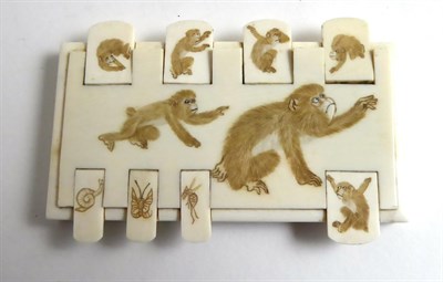 Lot 265 - A Meiji period ivory game counter carved with monkeys