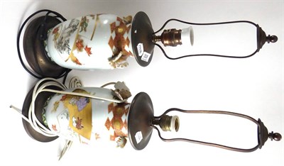 Lot 308 - A pair of Kutani porcelain baluster vases with butterfly handles, typically painted with asymmetric