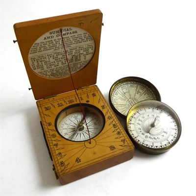 Lot 348 - A wooden sundial compass together with another example in a brass case