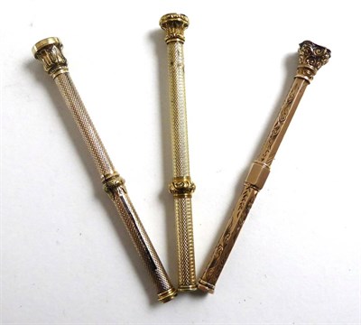 Lot 351 - A gold propelling pencil and two others