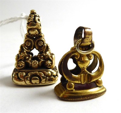 Lot 358 - A Victorian yellow metal fob fitted with a cornelian and a later gilt metal example (2)