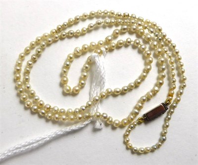 Lot 367 - A pearl necklace, the graduated pearls knotted to an oblong catch set with three rose cut diamonds