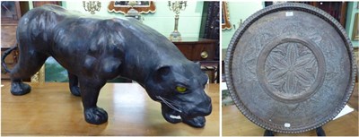 Lot 390 - A leather tiger figure and a large eastern circular tray