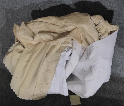 Lot 1032 - Nine assorted white cotton christening and night gowns, cream wool under dress, two silk...