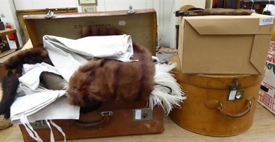 Lot 1082 - A grey top hat and gloves, a black top hat and a suitcase full of linen, furs, etc