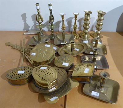 Lot 1112 - A group of brass chamber and candlesticks, brass chestnut warmers, etc