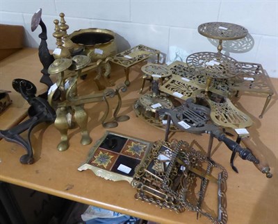 Lot 1113 - Brass trivets, brass photograph frames, brass fire dogs and a W. A. S. Benson brass jardiniere