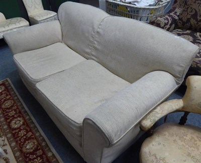 Lot 1139 - A cream two seater sofa