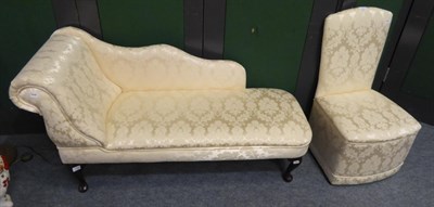 Lot 1140 - A reproduction upholstered daybed and a matching bedroom chair (2)